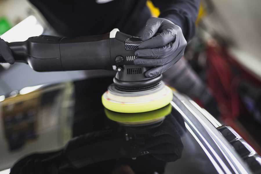 man working with polishing machine